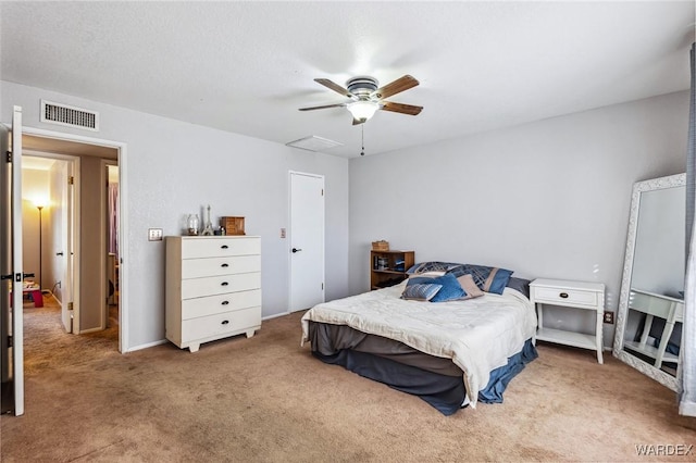 carpeted bedroom featuring visible vents and a ceiling fan