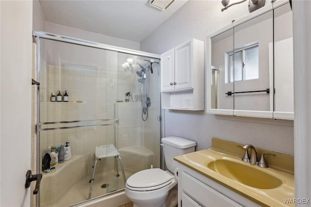 full bath featuring vanity, toilet, and a shower stall