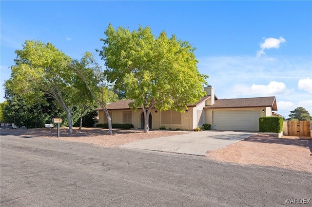 ranch-style house featuring concrete driveway, an attached garage, and stucco siding