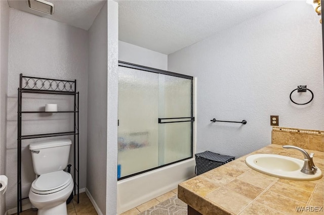 full bathroom with a textured wall, toilet, enclosed tub / shower combo, tile patterned flooring, and a textured ceiling