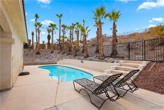 view of swimming pool with a fenced in pool, a fenced backyard, and a patio