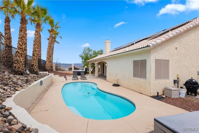 view of swimming pool featuring a fenced in pool, a patio area, fence, and area for grilling