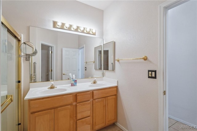 bathroom with tile patterned floors, a sink, and double vanity