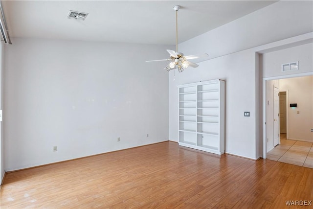 unfurnished room with light wood-type flooring, ceiling fan, and visible vents