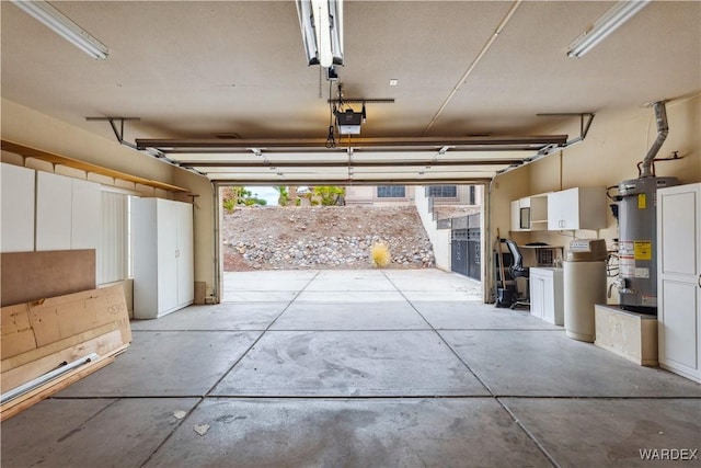 garage with a garage door opener and water heater