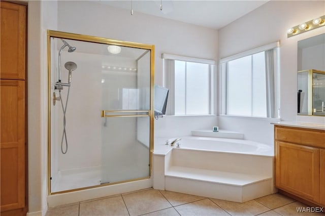 bathroom with vanity, a shower stall, a bath, and tile patterned floors