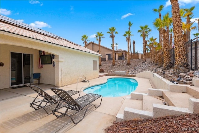 view of swimming pool with a fenced in pool, fence, and a patio