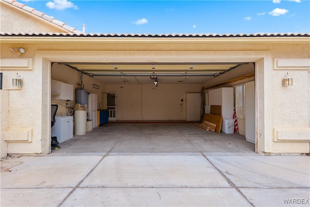 garage featuring water heater and concrete driveway