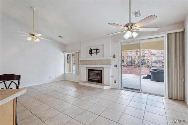 unfurnished living room featuring lofted ceiling, light tile patterned flooring, visible vents, and a ceiling fan