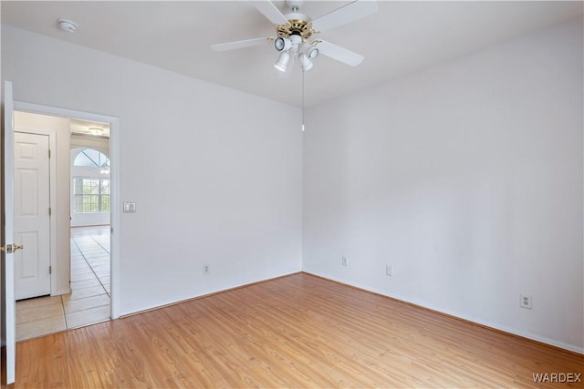 spare room featuring a ceiling fan and light wood-style floors