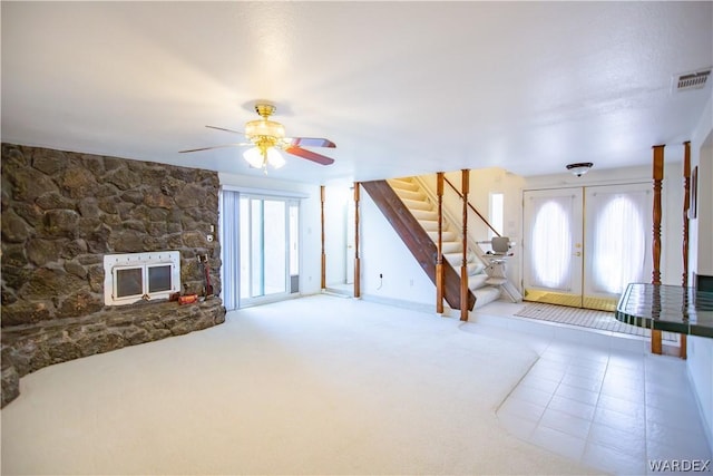 unfurnished living room featuring visible vents, ceiling fan, stairway, tile patterned floors, and french doors