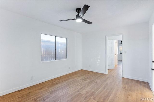 unfurnished bedroom featuring light wood-style flooring, baseboards, and a ceiling fan