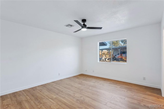 unfurnished room with light wood-style flooring, visible vents, baseboards, and ceiling fan