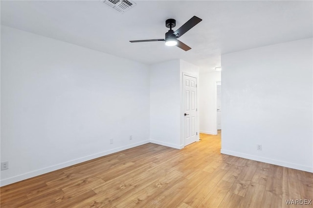 unfurnished room with a ceiling fan, visible vents, light wood-style flooring, and baseboards