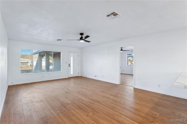 spare room with visible vents, a healthy amount of sunlight, and light wood-style flooring