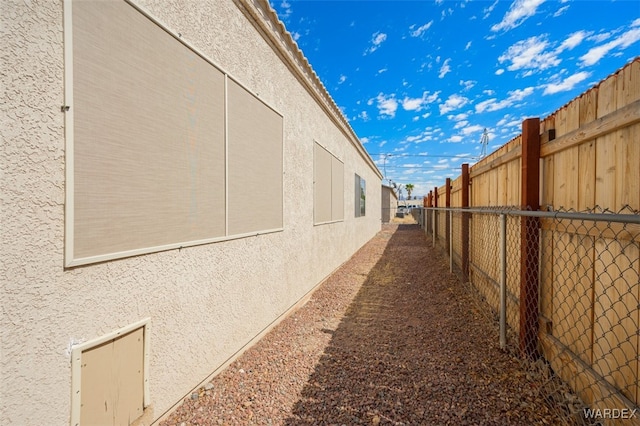 view of home's exterior featuring fence and stucco siding