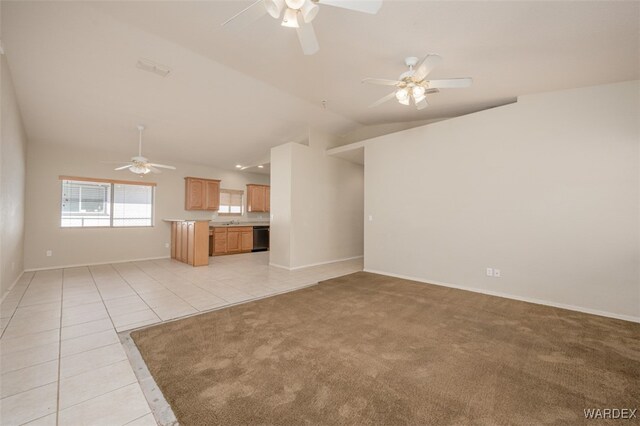 unfurnished living room featuring light tile patterned floors, ceiling fan, light carpet, baseboards, and vaulted ceiling