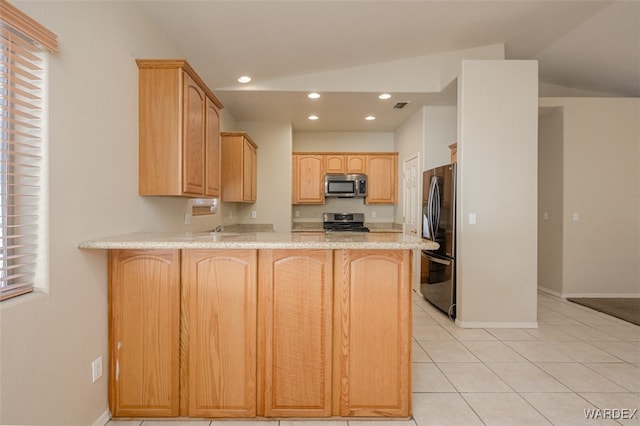 kitchen featuring a peninsula, visible vents, stainless steel appliances, and light brown cabinetry