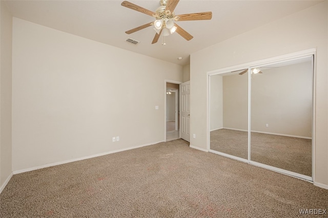 unfurnished bedroom with a ceiling fan, visible vents, baseboards, a closet, and carpet