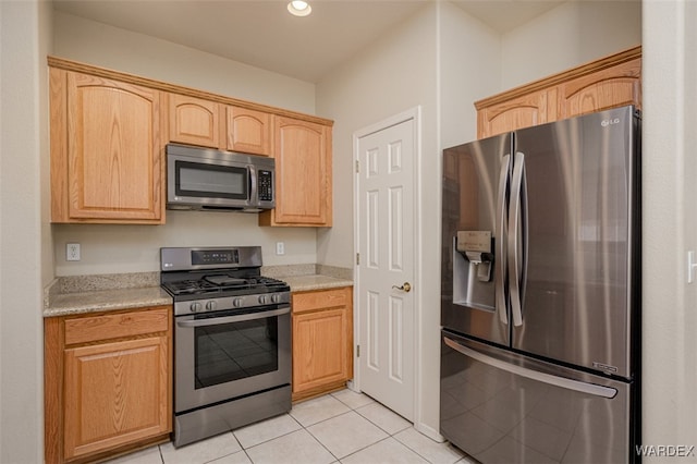 kitchen featuring recessed lighting, light countertops, appliances with stainless steel finishes, light brown cabinets, and light tile patterned flooring