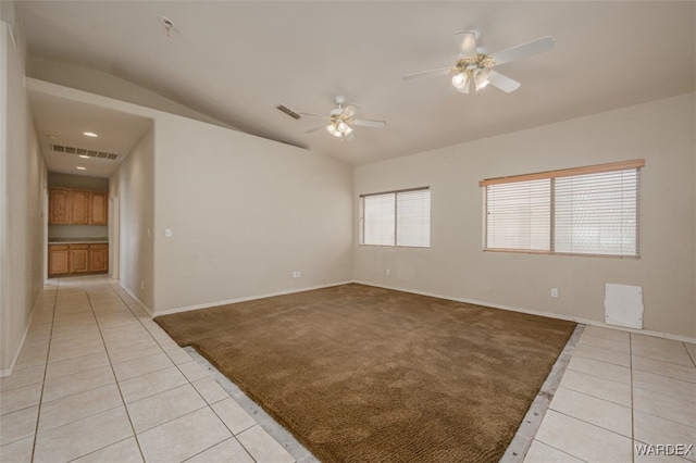 unfurnished room featuring light colored carpet, visible vents, and light tile patterned floors