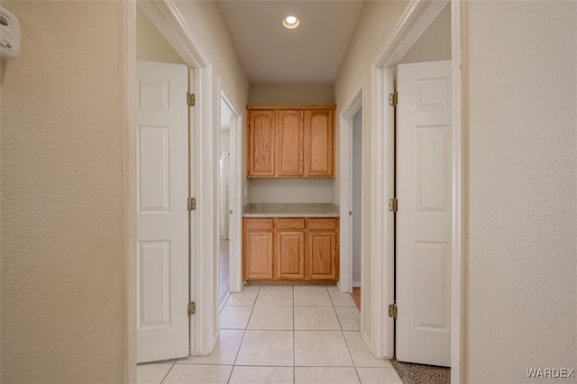 corridor with light tile patterned floors and recessed lighting