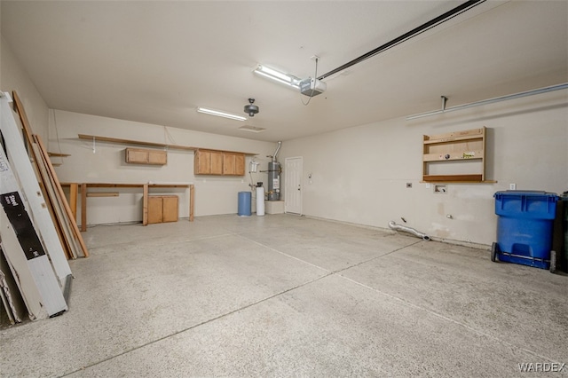 garage with strapped water heater and a garage door opener