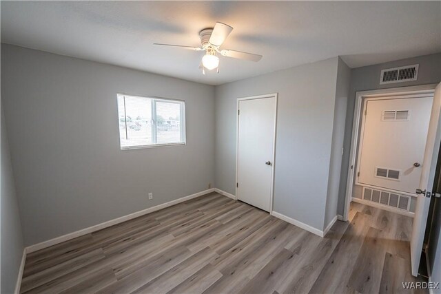2615 E Devlin Ave, Kingman, AZ 86409 - unfurnished bedroom featuring wood finished floors, a closet, and a ceiling fan