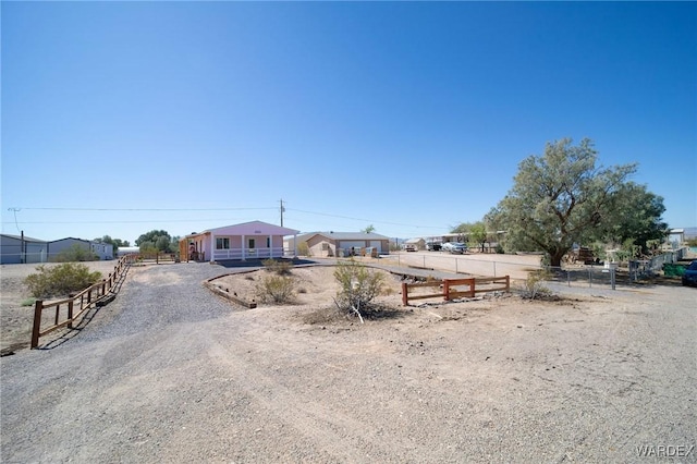 view of front of home featuring fence