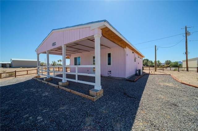 view of side of home with central AC, an outdoor structure, and an exterior structure