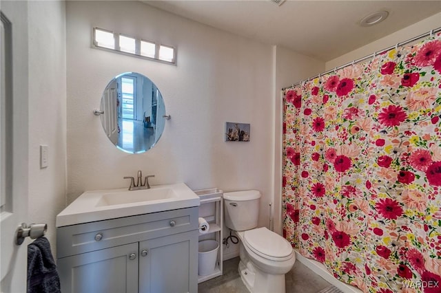 full bath featuring vanity, toilet, and baseboards