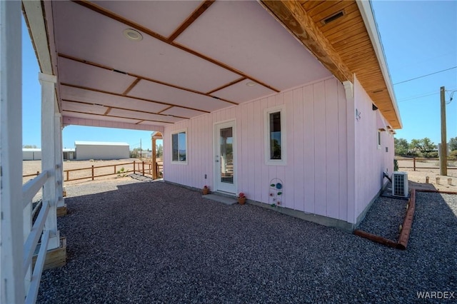 rear view of house featuring central air condition unit and visible vents