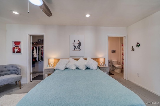 bedroom with ceiling fan, recessed lighting, baseboards, a walk in closet, and ensuite bath