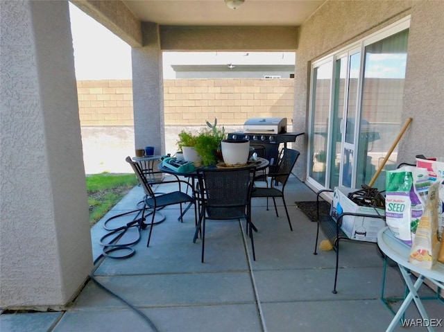 view of patio / terrace featuring outdoor dining area, a grill, and fence