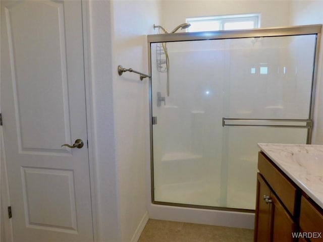 full bath with a stall shower and vanity