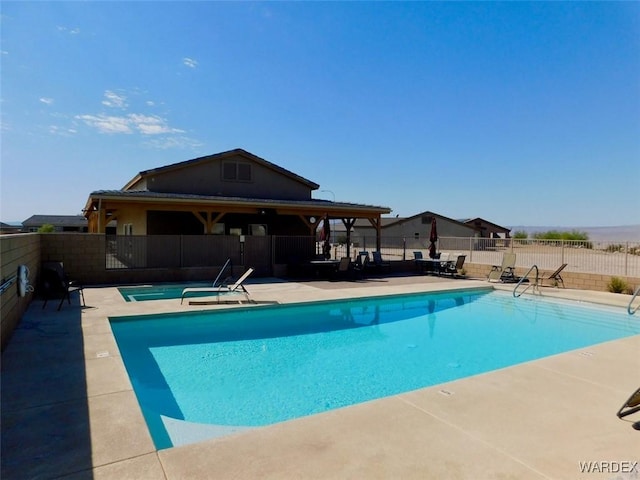 community pool featuring a patio area and fence