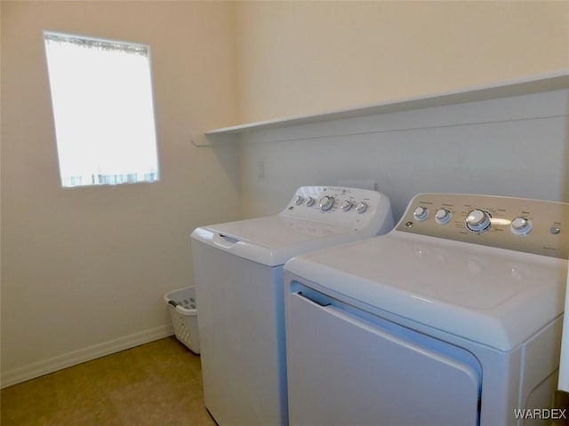 laundry room with laundry area, baseboards, and washer and dryer