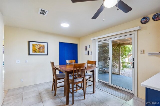 dining room featuring light tile patterned floors, ceiling fan, and visible vents