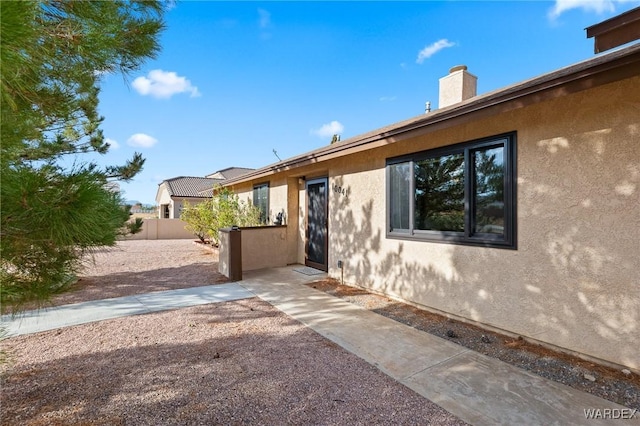 view of home's exterior featuring fence and stucco siding