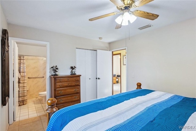 bedroom with a closet, visible vents, ensuite bathroom, a ceiling fan, and light tile patterned flooring