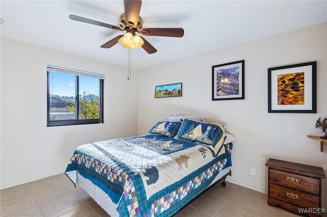 bedroom featuring ceiling fan, baseboards, and light tile patterned floors