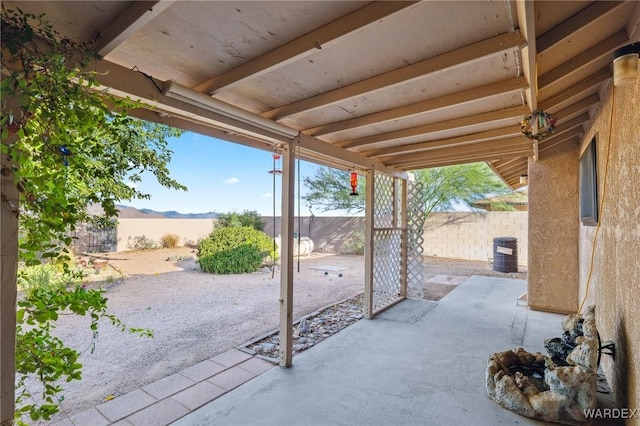 view of patio with cooling unit and a fenced backyard