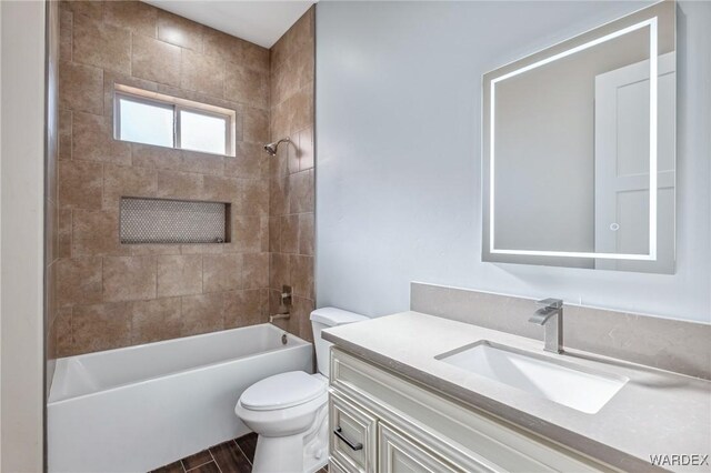 bathroom featuring shower / bath combination, vanity, and toilet