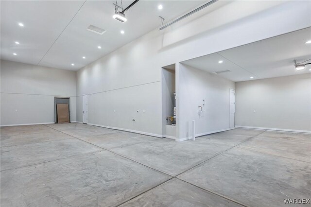 garage with recessed lighting and baseboards