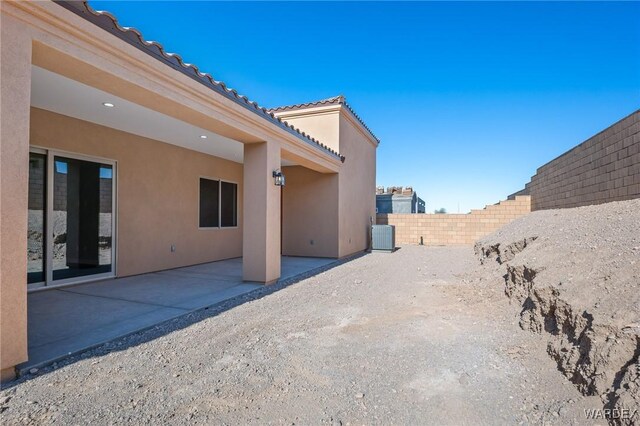 view of yard featuring a patio, a fenced backyard, and central air condition unit