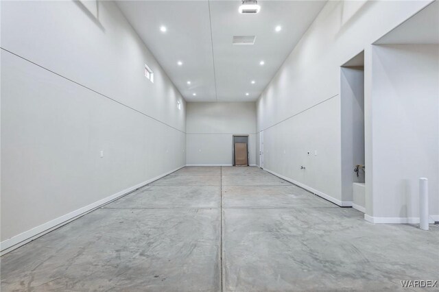 unfurnished room featuring recessed lighting, concrete floors, and baseboards