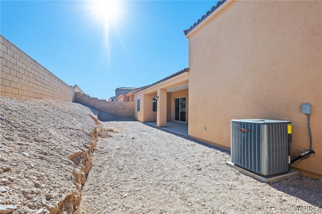 view of yard featuring a patio area, central AC, and a fenced backyard