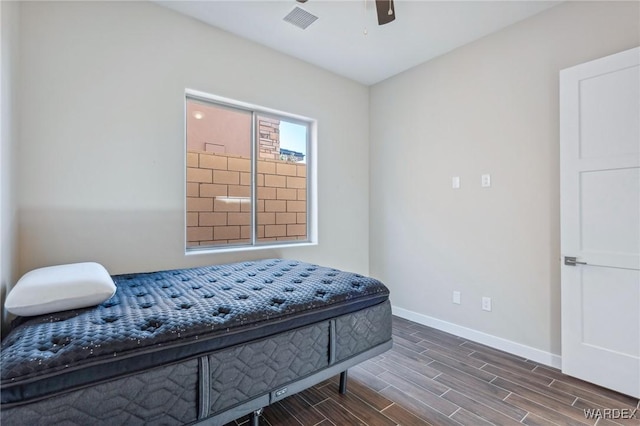 bedroom with wood tiled floor, visible vents, ceiling fan, and baseboards