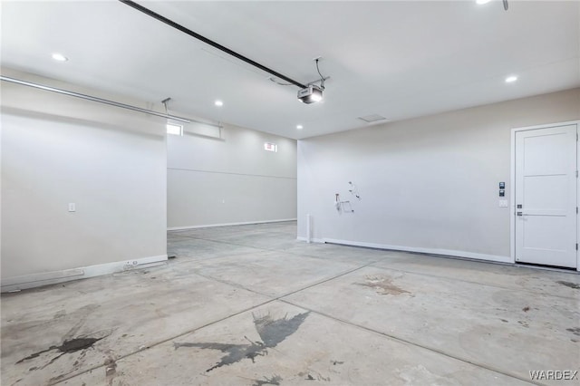 garage with a garage door opener, recessed lighting, and baseboards