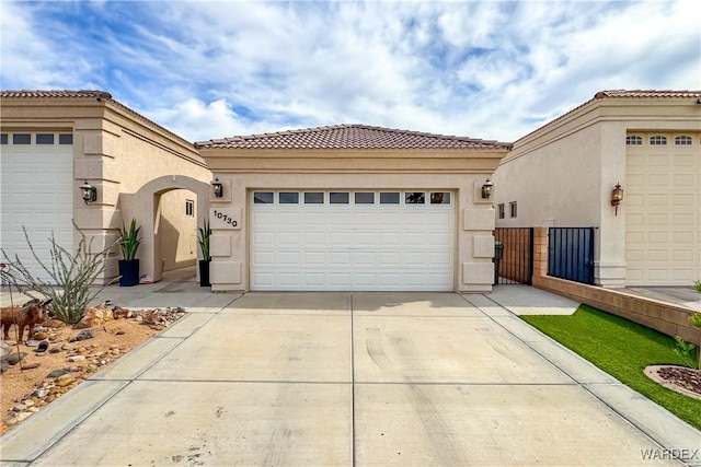 10730 S River Terrace Dr, Mohave Valley, AZ 86440 - exterior space featuring concrete driveway, stucco siding, a tile roof, a garage, and fence